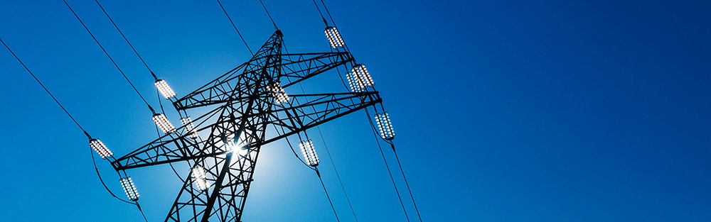 Electricity pylon in front of the blue sky.